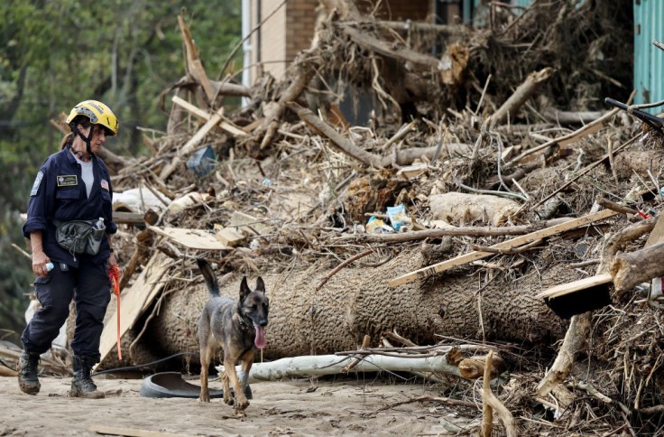A member of the FEMA searches a flood-damaged property