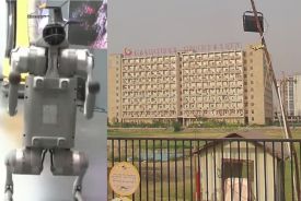 Robot dog (left) stands on display at the India AI