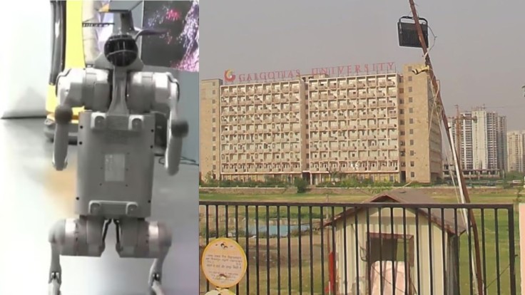Robot dog (left) stands on display at the India AI